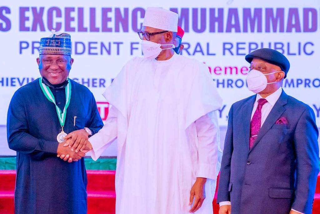 President Buhari in a handshake with Abdul Samad Rabiu